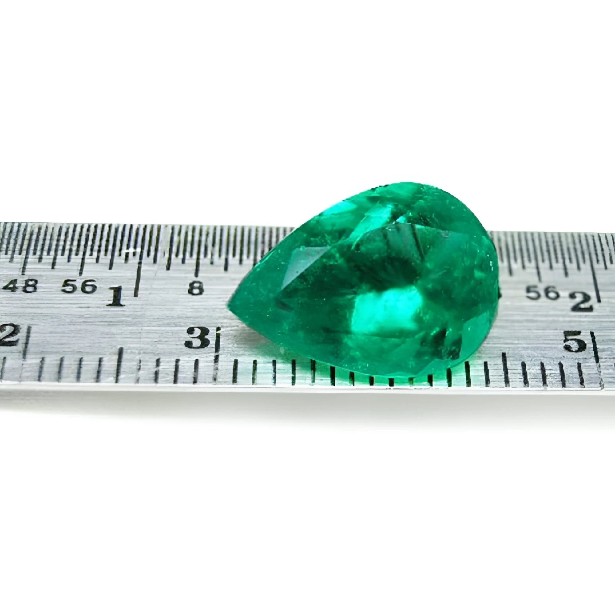 4.17 ct pear-cut natural emerald from Muzo Colombia, vibrant medium-deep green, shown on a ruler.
