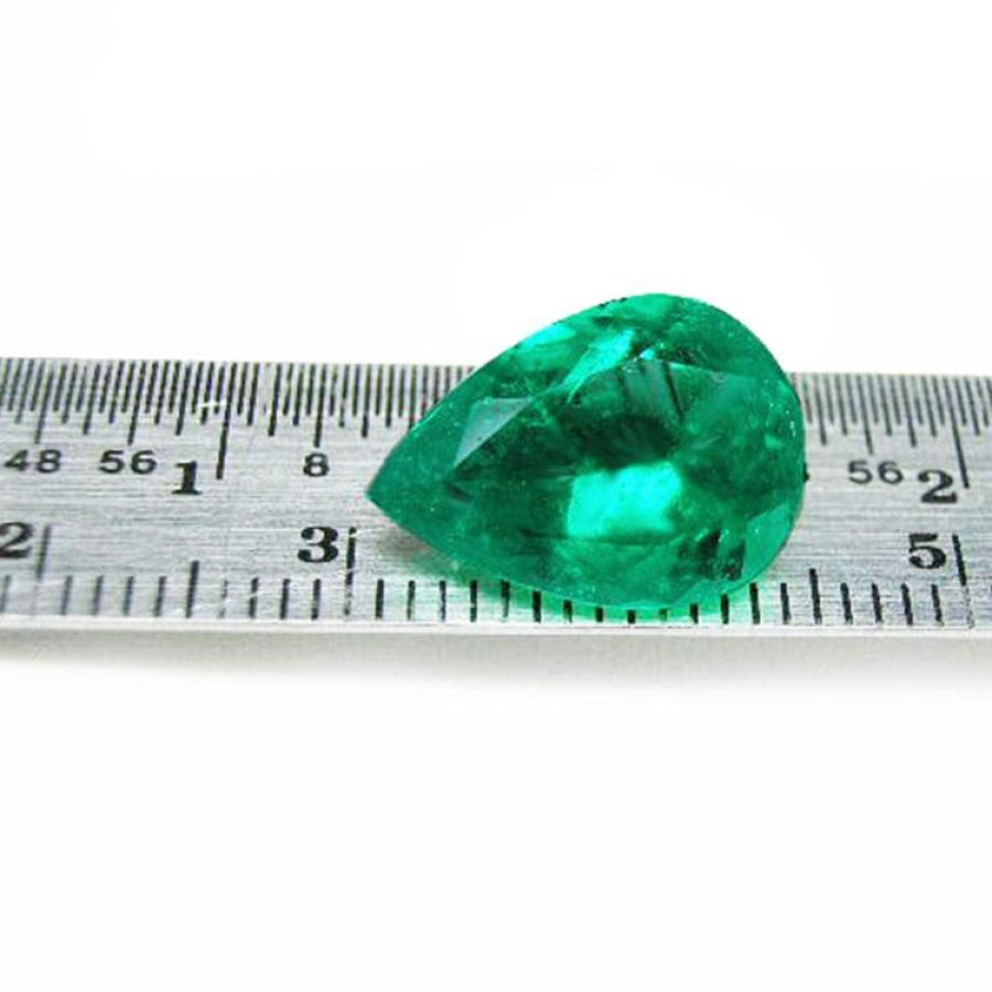 4.17 ct pear-cut natural emerald from Muzo Colombia, vibrant medium-deep green, shown on a ruler.