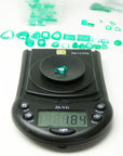 Pear cut natural colombian emerald muzo mine, on electronic scale for weight view