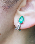 Close-up of an ear wearing gift for Mother's Day emerald clip on earring.