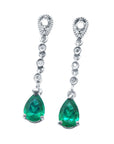 Pair of emerald teardrop earrings with diamond accent on a front position top view