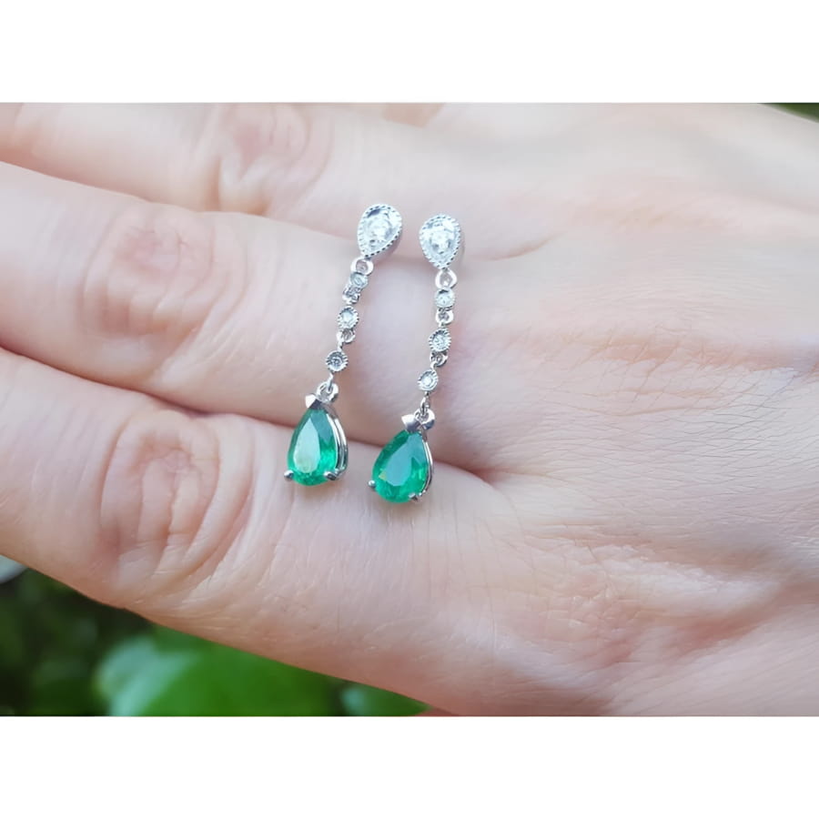 1.05 ct. pear-shaped emerald drop earrings in 14K white gold with diamond accents.