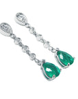 Emerald and diamond earrings on a right-side position profile view.