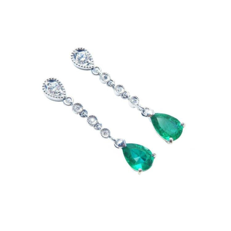 Pear shaped emerald drop earrings in 14k white gold, right position top view