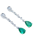Pear shaped emerald drop earrings in 14k white gold, right position top view