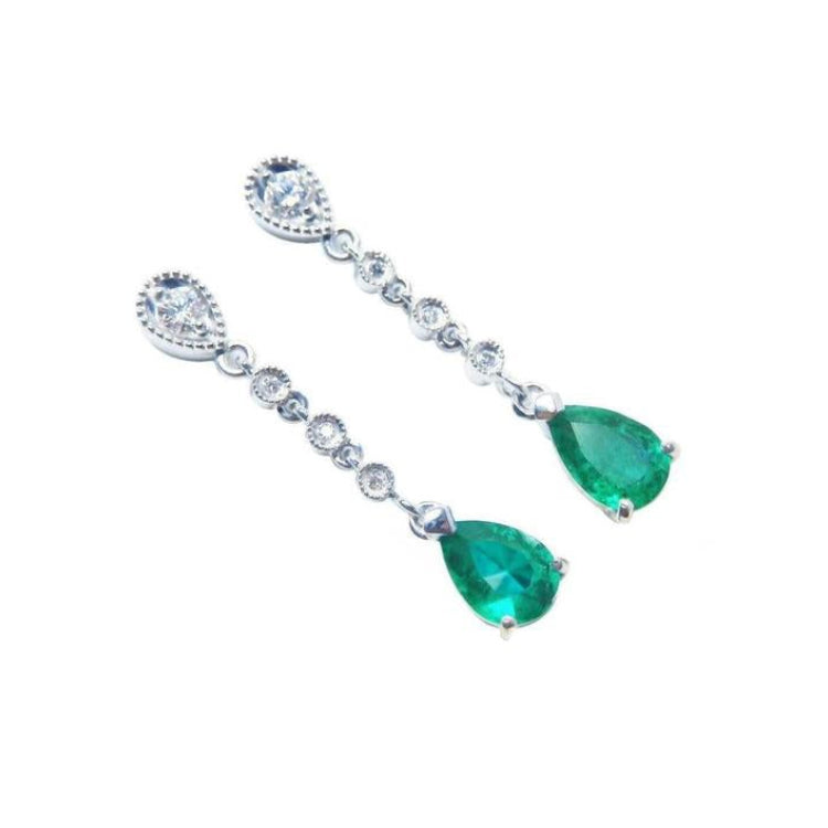 A pair of pear shaped natural colombian emerald drop earrings accent diamonds crafted in 14k white gold.