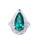 An emerald ring, pear shaped held by three prong set, encircled by double halo diamond, in 14k white gold.