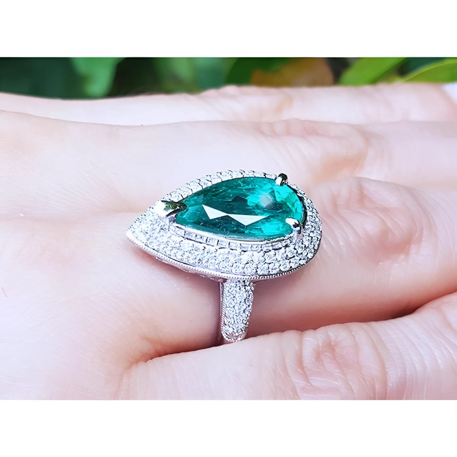 Pear-shaped 3.35 ct. emerald engagement ring in 14K white gold with diamond halo.