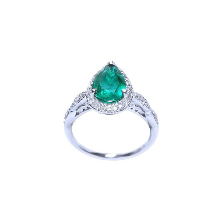 Pear cut emerald ring top and lateral gallery profile view on a white background.