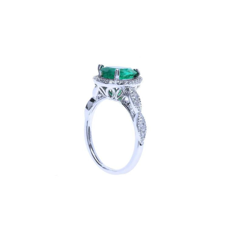 1.43 ct teardrop emerald engagement ring in 14K white gold with diamond halo and twisted band.