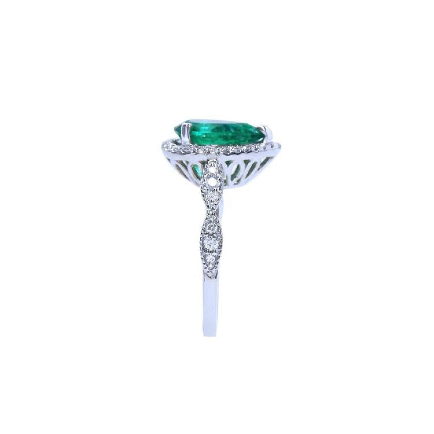 1.43 ct teardrop emerald engagement ring in 14K white gold with diamond halo and accents.