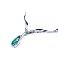 14K white gold necklace with a pear-cut emerald pendant surrounded by diamonds and entwined chevron design.