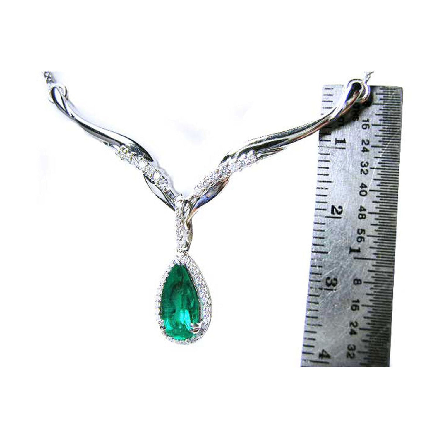 1.28 carat pear cut emerald necklace in 14K white gold with diamond halo and chevron design.