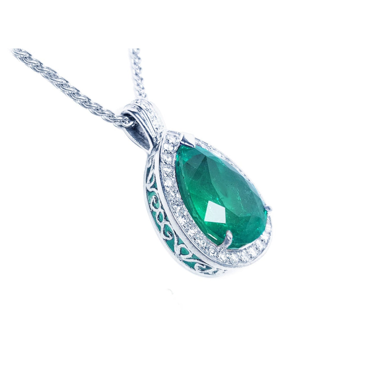 Pear-shaped emerald pendant with diamond halo and intricate 14K white gold setting on a chain.