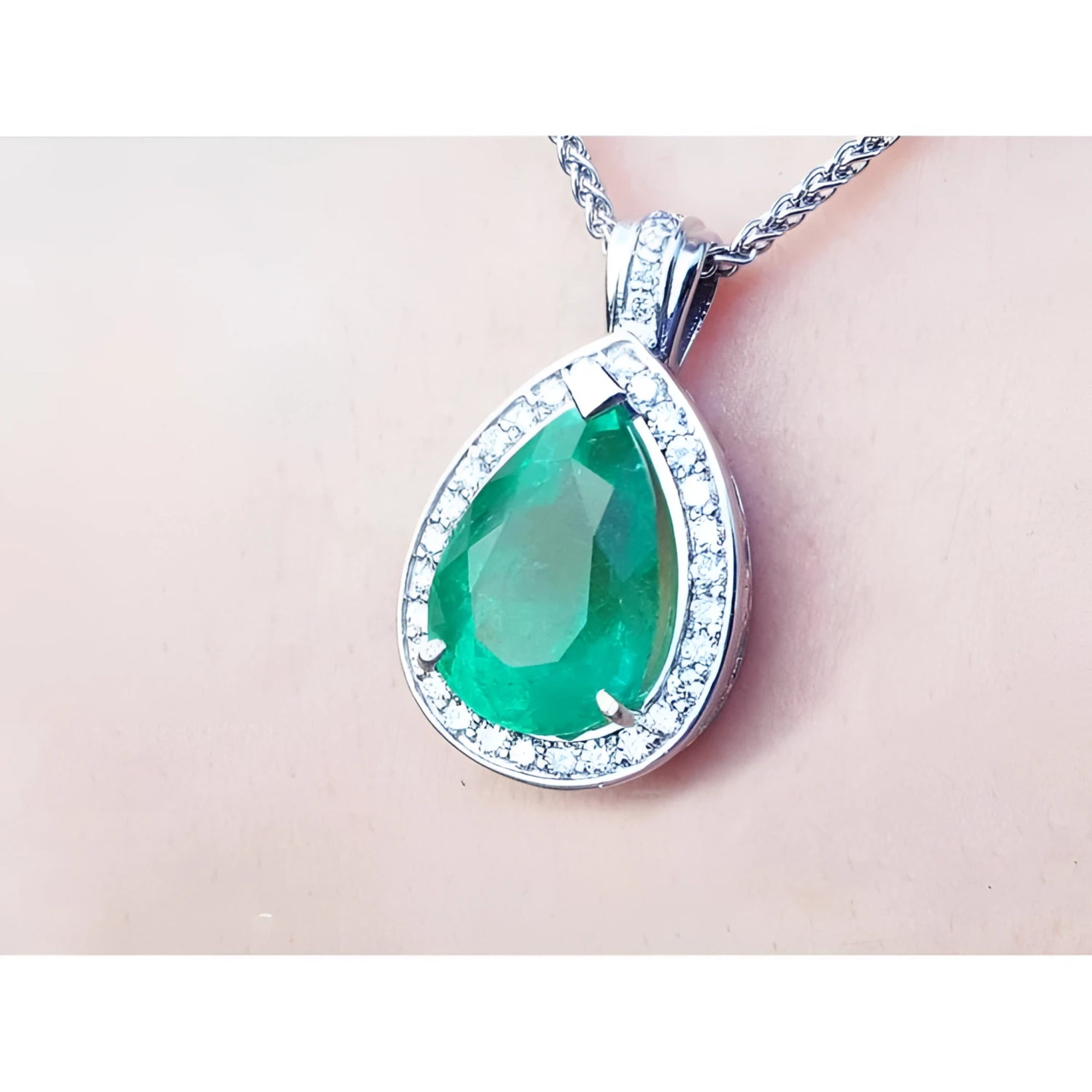 8.64 ct. pear-shaped emerald pendant with diamond halo in 14K white gold.