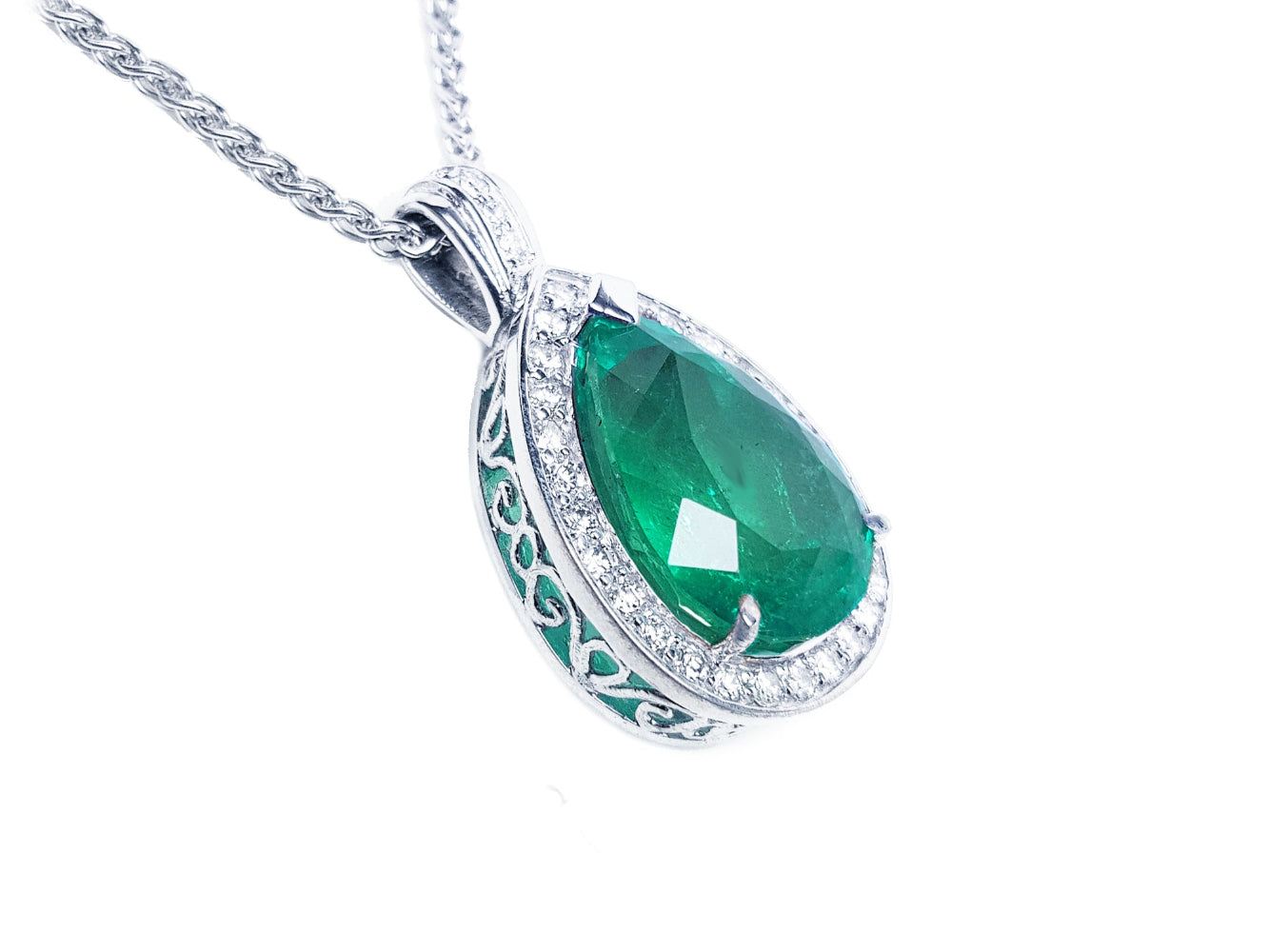 A pear shaped natural colombian emerald pendant on its right side position topside and gallery visibles.