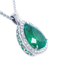 A pear shaped natural colombian emerald pendant on its right side position topside and gallery visibles.