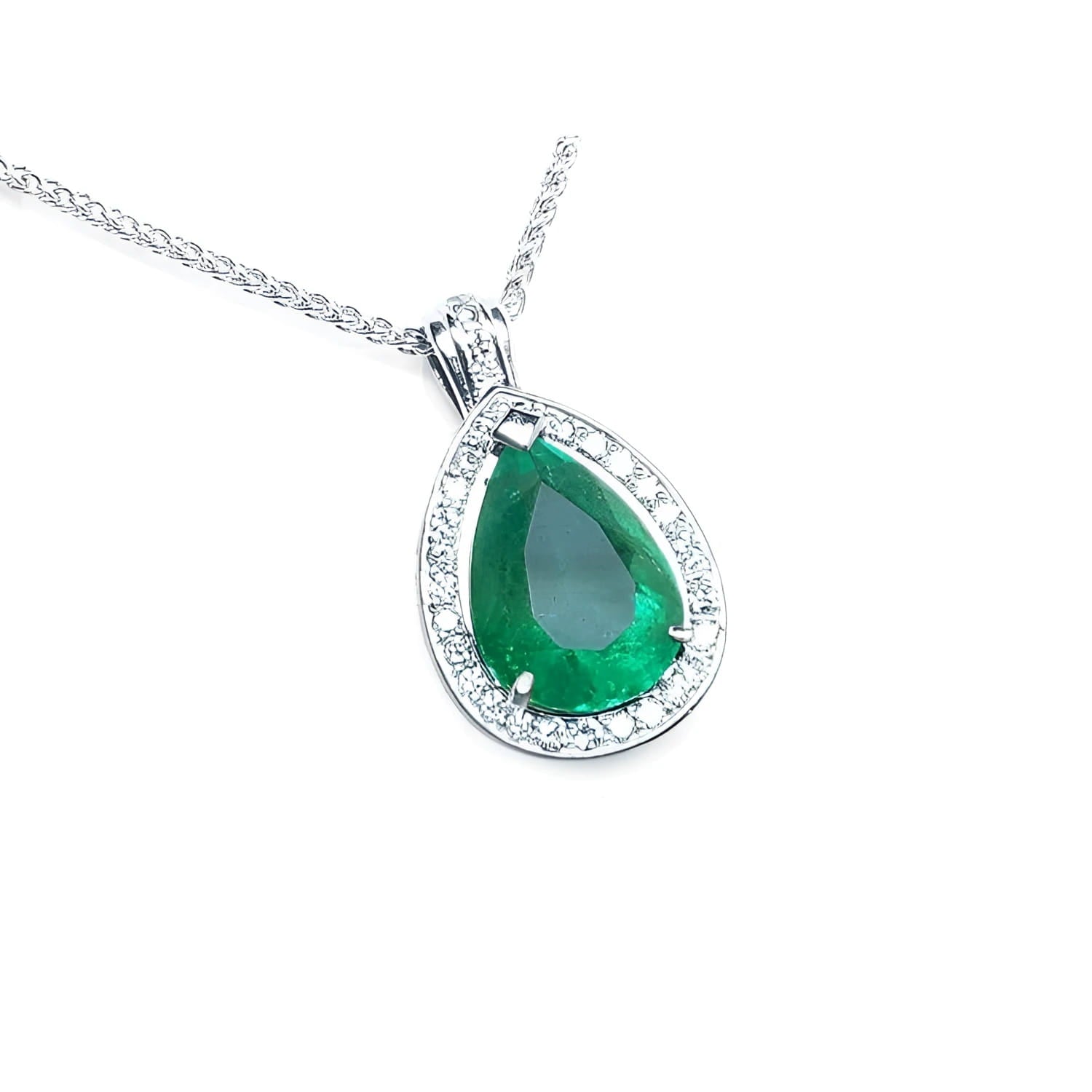 Teardrop-shaped emerald pendant with diamond accents on a topside view.