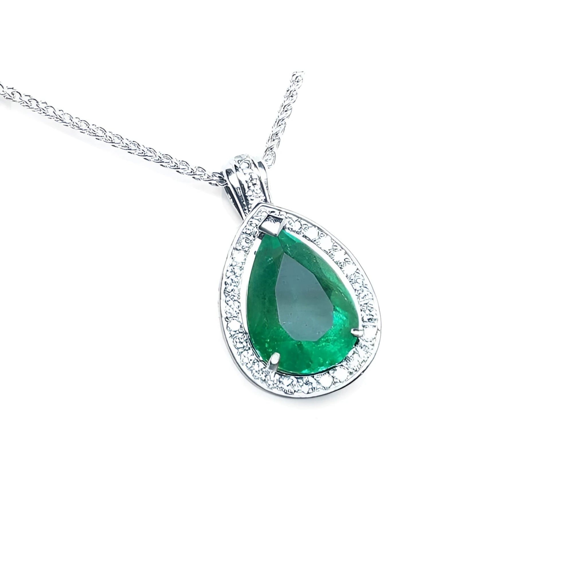 Teardrop-shaped emerald pendant with diamond accents on a topside view.
