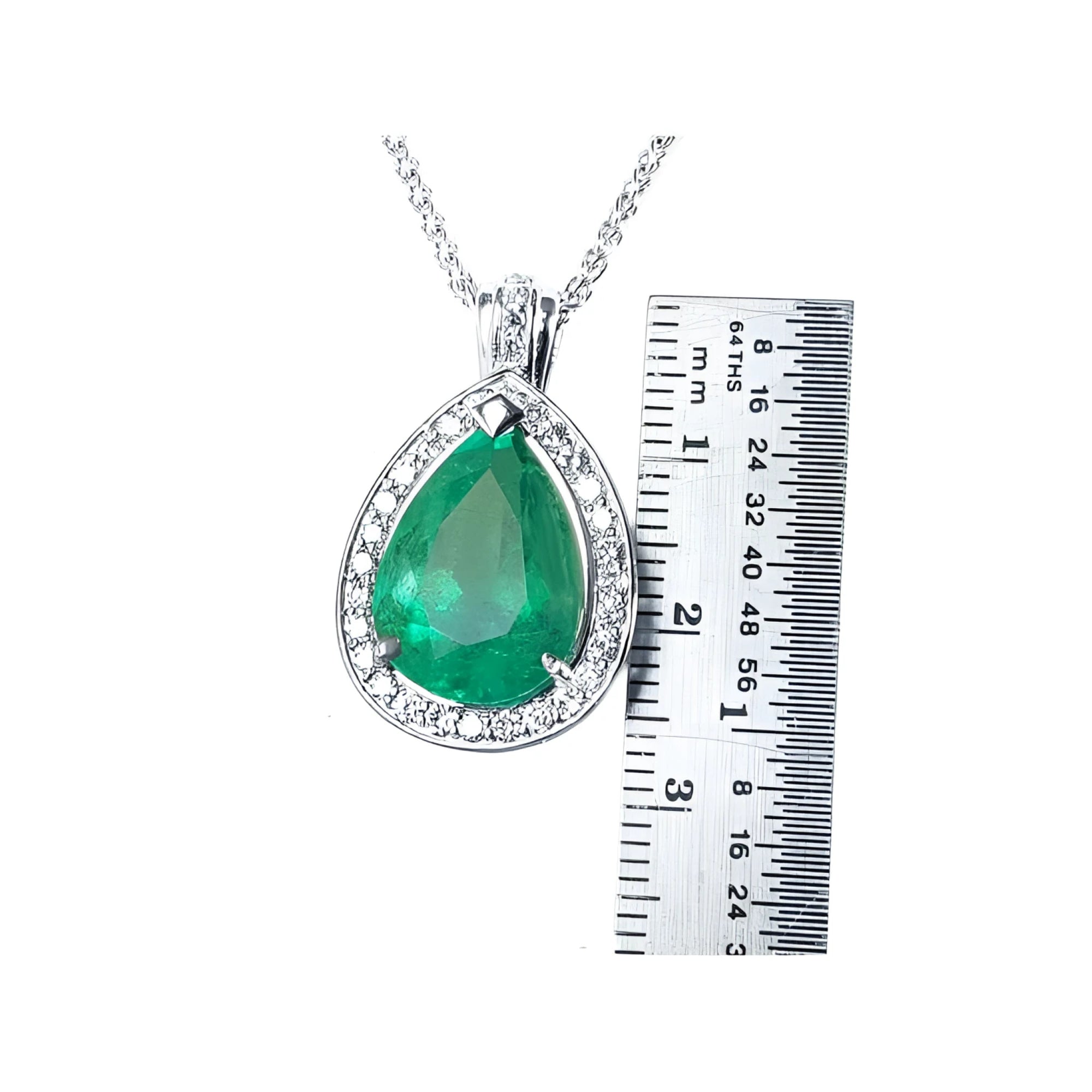 8.64 ct. pear-shaped emerald pendant with halo diamonds in 14K white gold, next to a ruler.