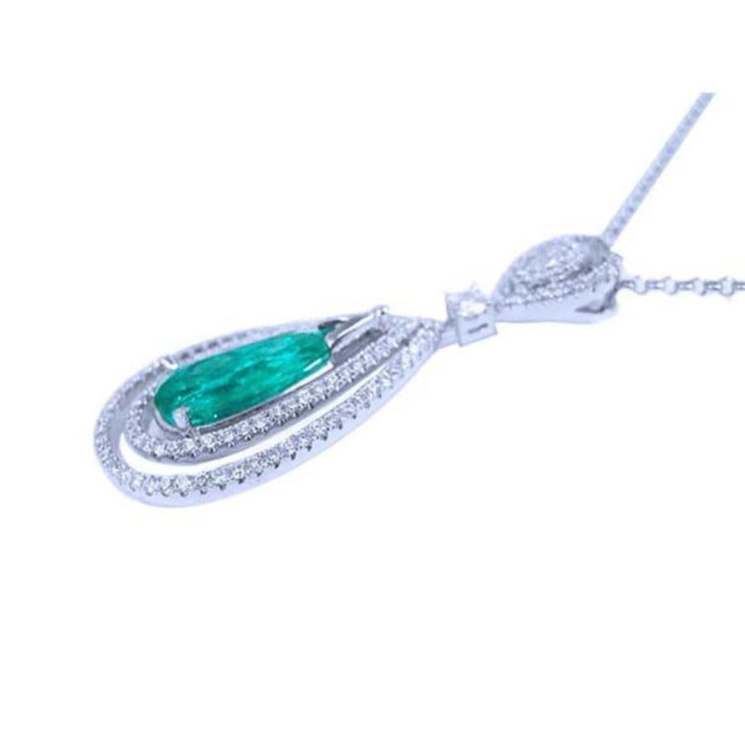 Teardrop emerald pendant with double diamond halo in 18K white gold.