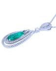 Teardrop emerald pendant with double diamond halo in 18K white gold.