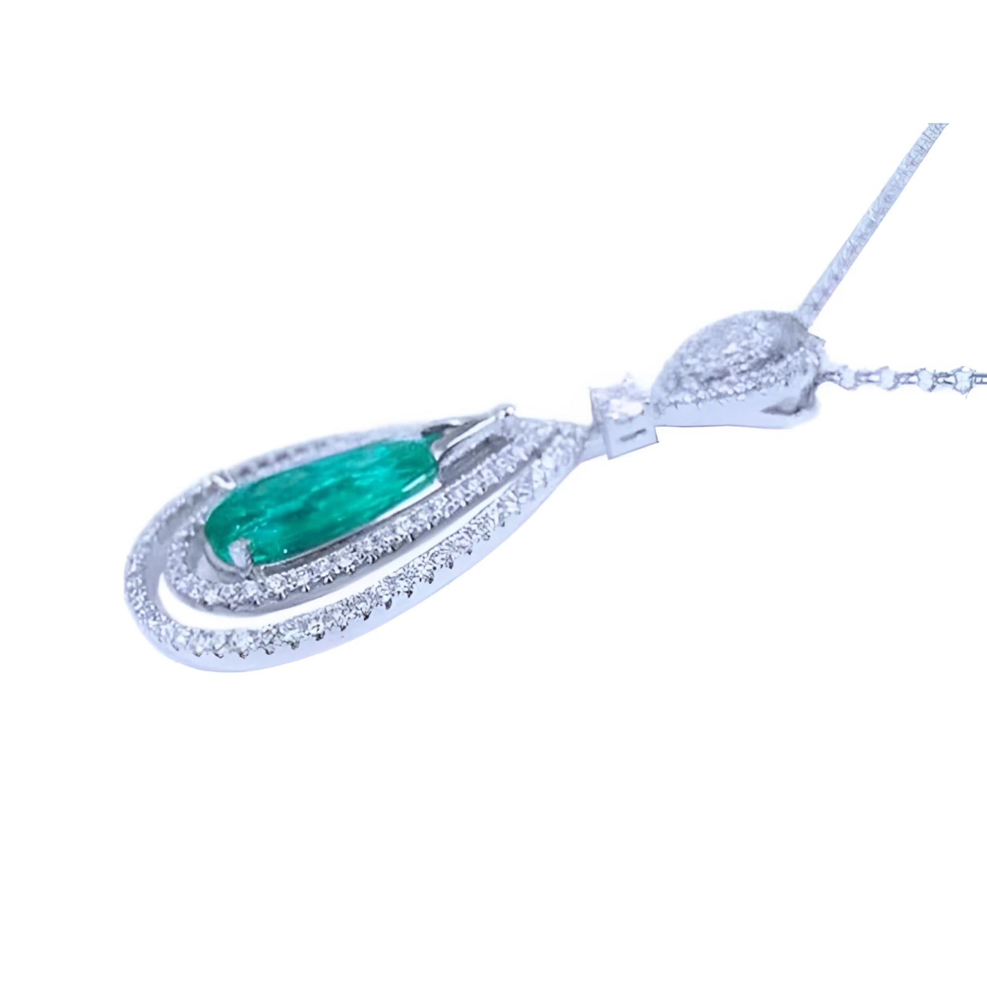Teardrop emerald pendant with double diamond halo in 18K white gold.