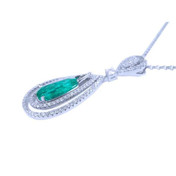 The side profile of a natural emerald teardrop with two rows of diamonds in white gold