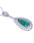 Teardrop emerald pendant with double diamond halo, set in 18K white gold.