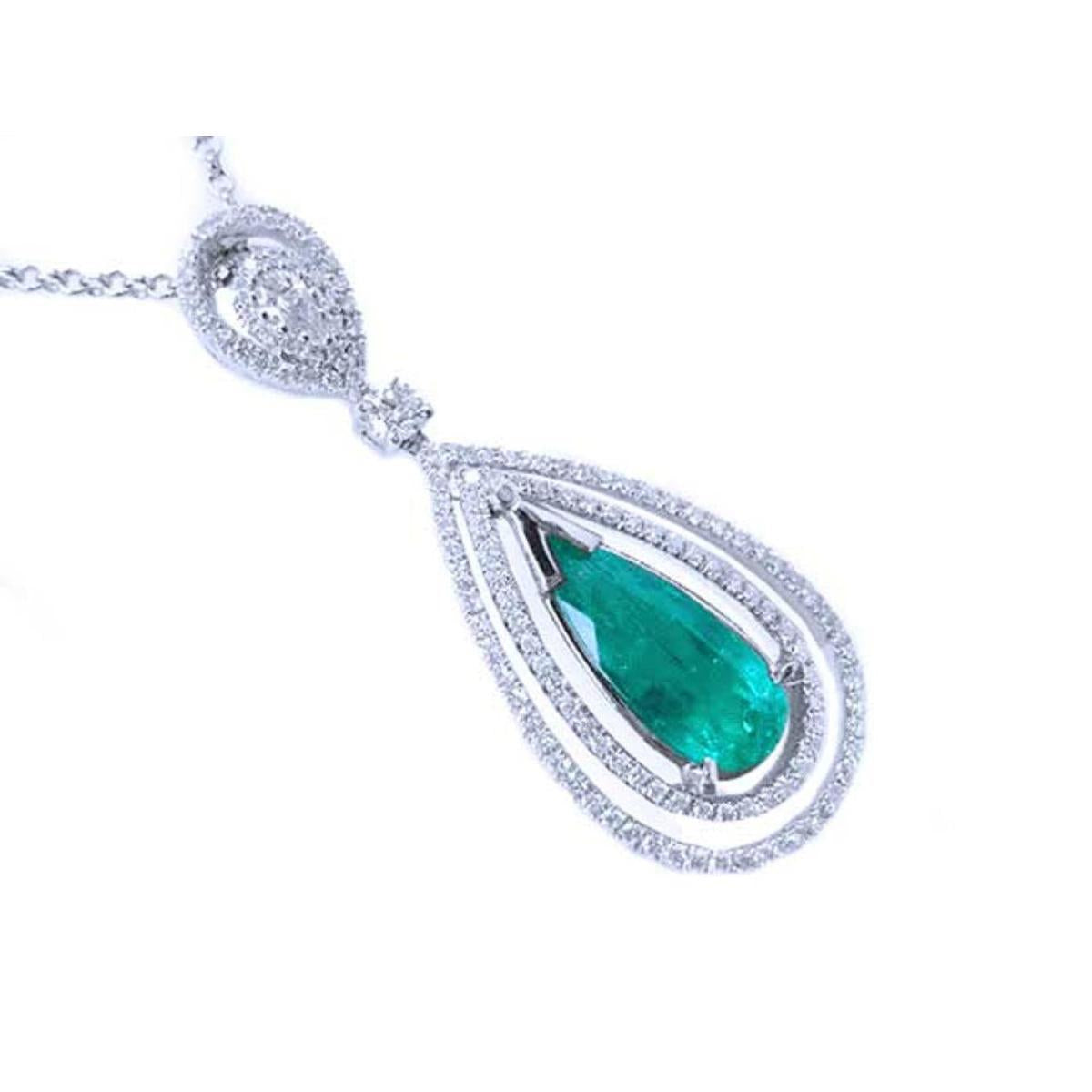 A teardrop emerald in a double halo diamonds set in 18k white gold, topside view.