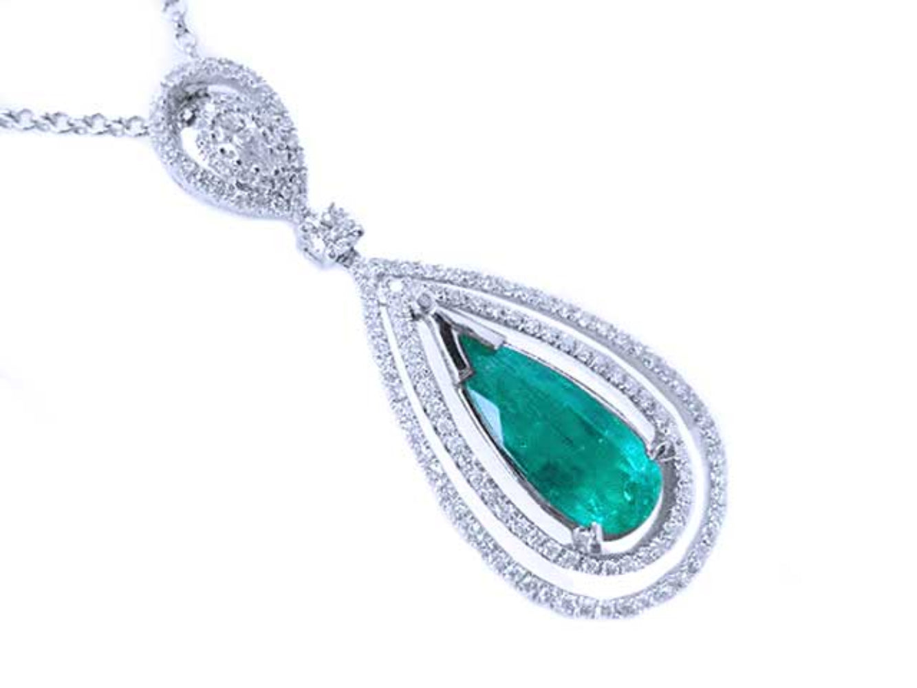 A teardrop emerald in a double halo diamonds set in 18k white gold, topside view.