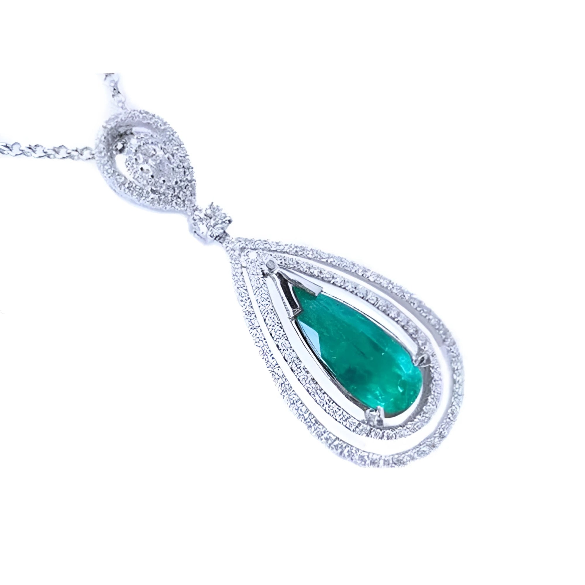 A teardrop emerald in a double halo diamonds set in 18k white gold, topside view.