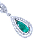 A teardrop emerald in a double halo diamonds set in 18k white gold, topside view.