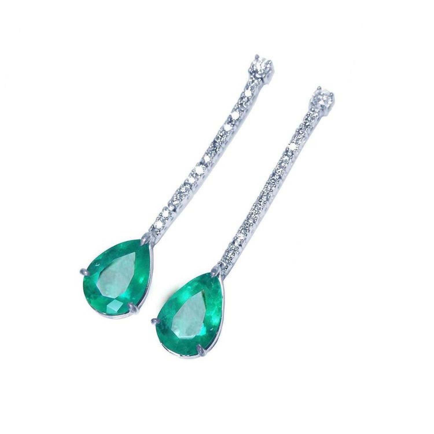 Pear shape 5.05 ct. emerald drop earrings in 18K white gold with diamond accents.