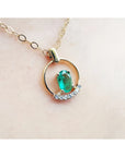 14k yellow gold necklace with oval natural Colombian emerald and diamond accents.
