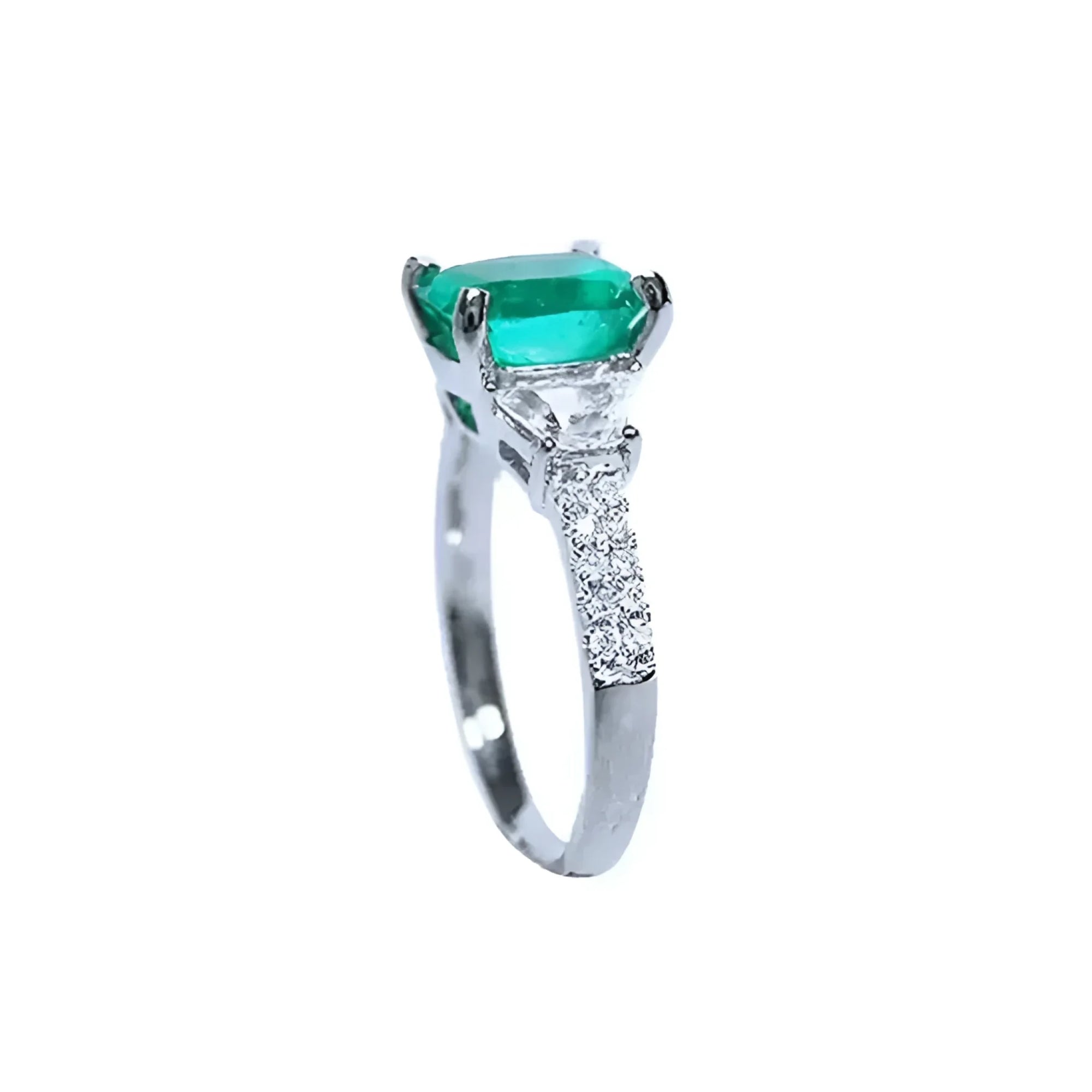 Anillo de compromiso de oro blanco 18k con esmeralda colombiana ovalada y diamantes trapezoide.