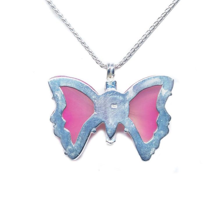 Back of a pink natural agate butterfly pendant in a sterling silver 925 setting on a silver necklace.