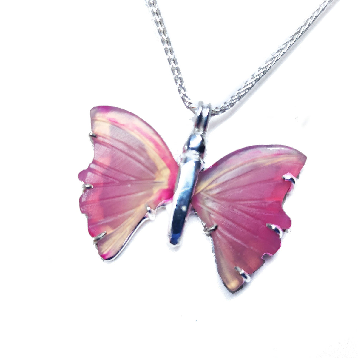 Butterfly-shaped agate pendant on a silver chain left side profile against a white background