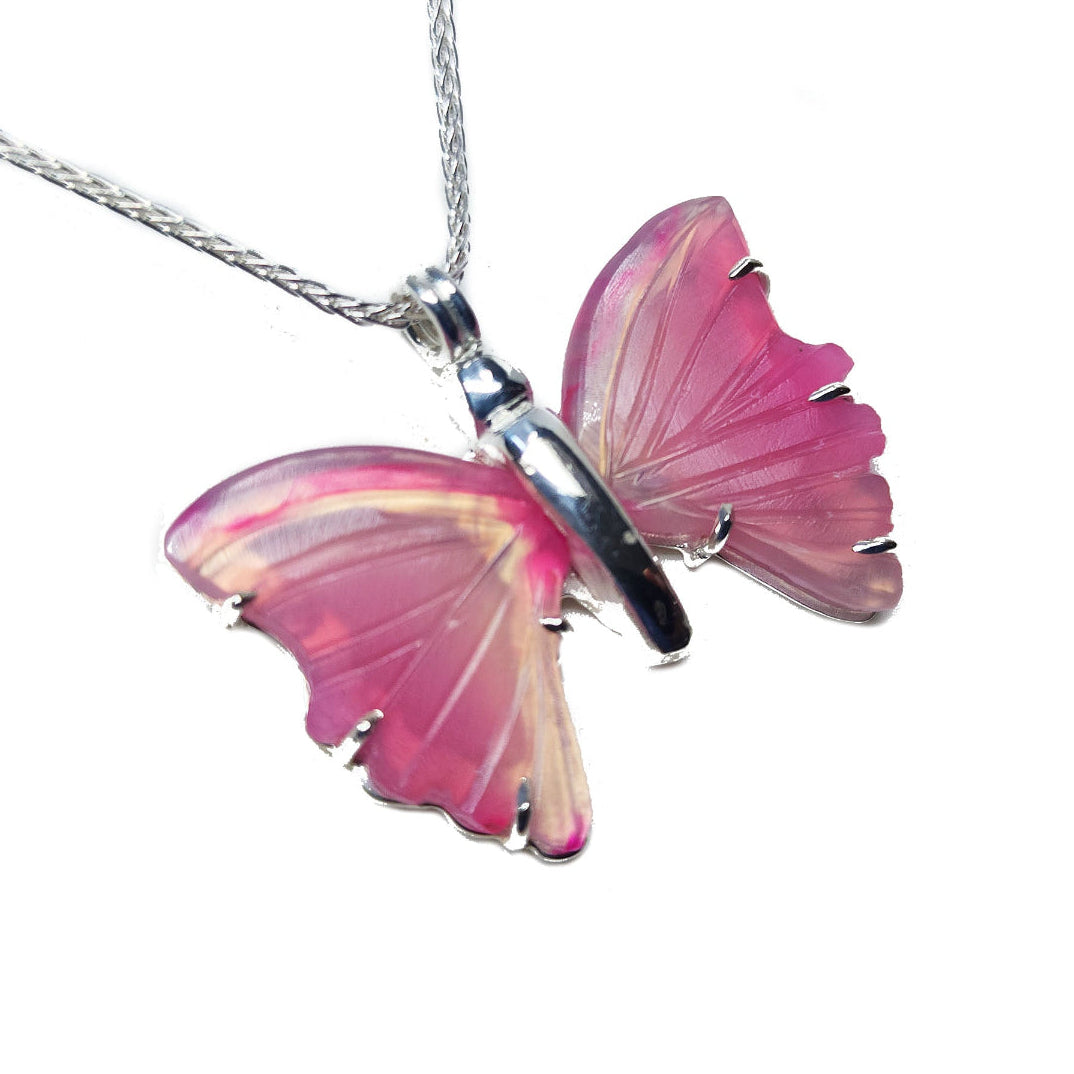 Natural agate butterfly-shaped sterling silver pendant with pink wings on a white background