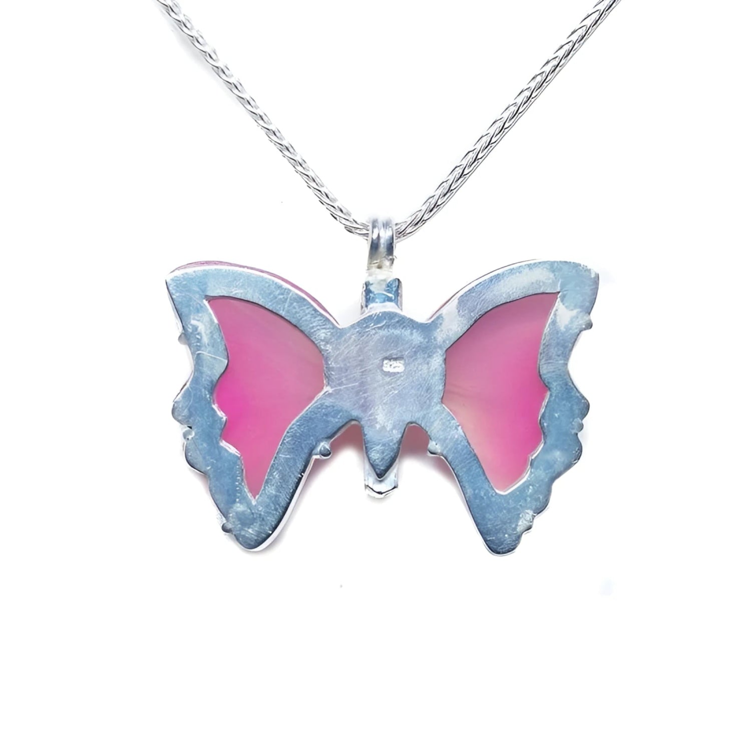 Back of a pink natural agate butterfly pendant in a sterling silver 925 setting on a silver necklace.