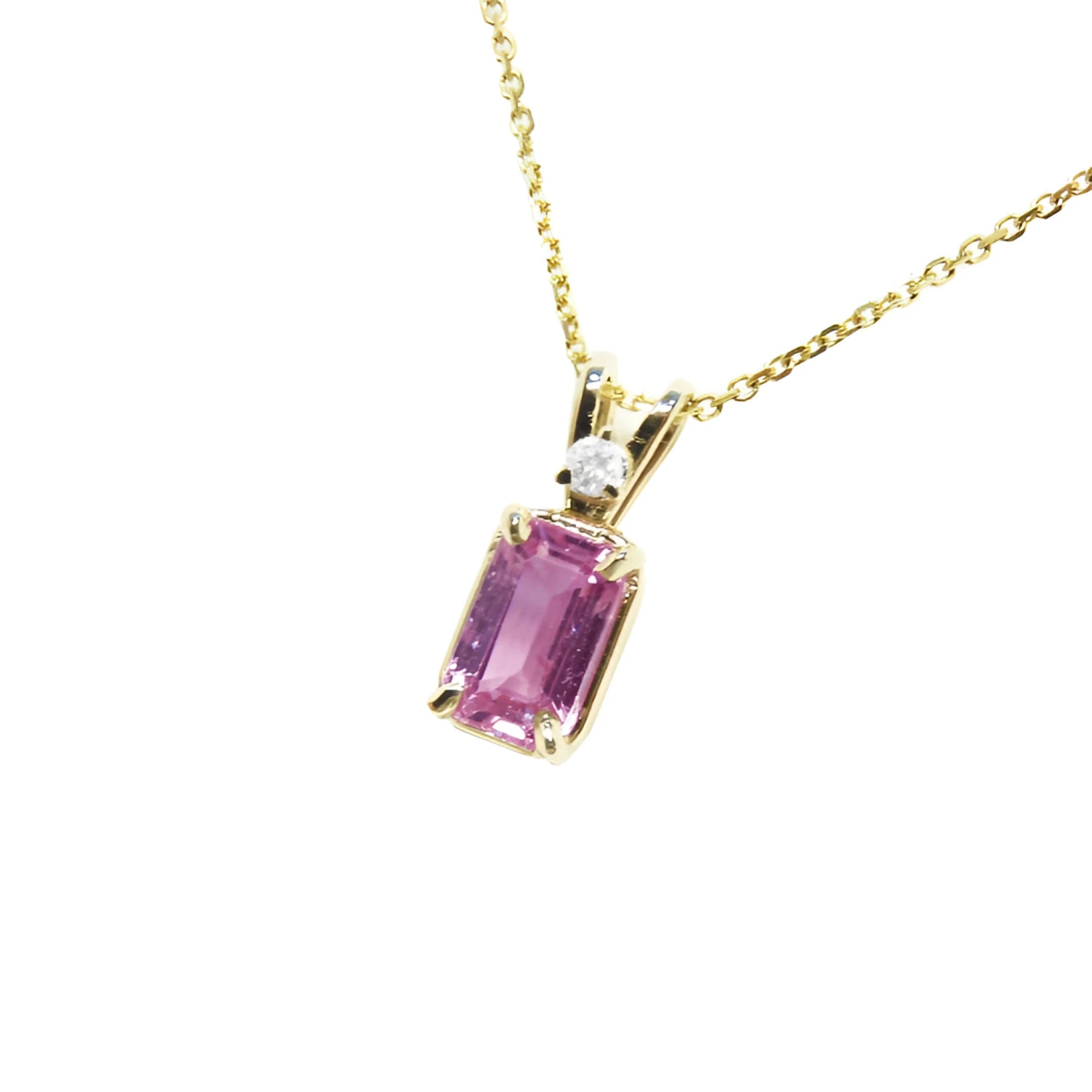 Genuine emerald cut pink sapphire and diamond pendant in 14k gold.