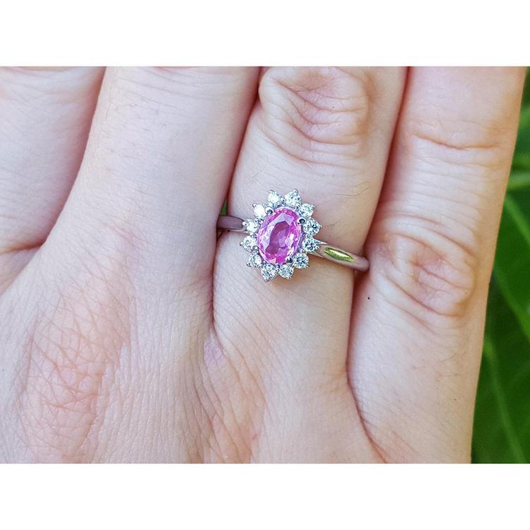 hand wearing a natural pink sapphire ring for women halo diamond in 14k white gold, 