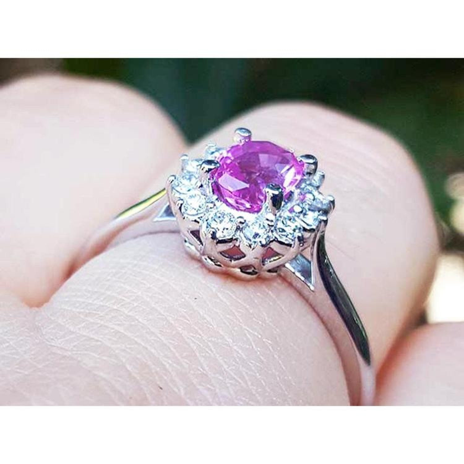 14K white gold ring with oval pink sapphire and diamond halo.