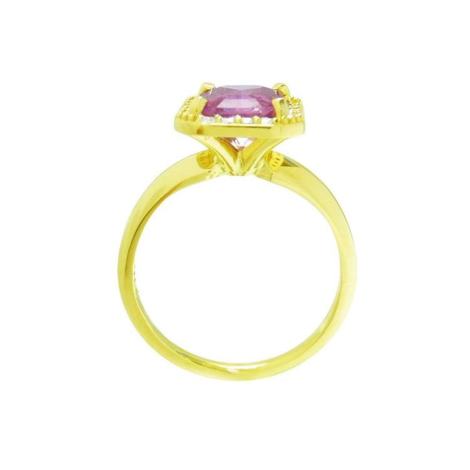 Emerald-cut pink sapphire ring with diamond halo in 14K yellow gold.