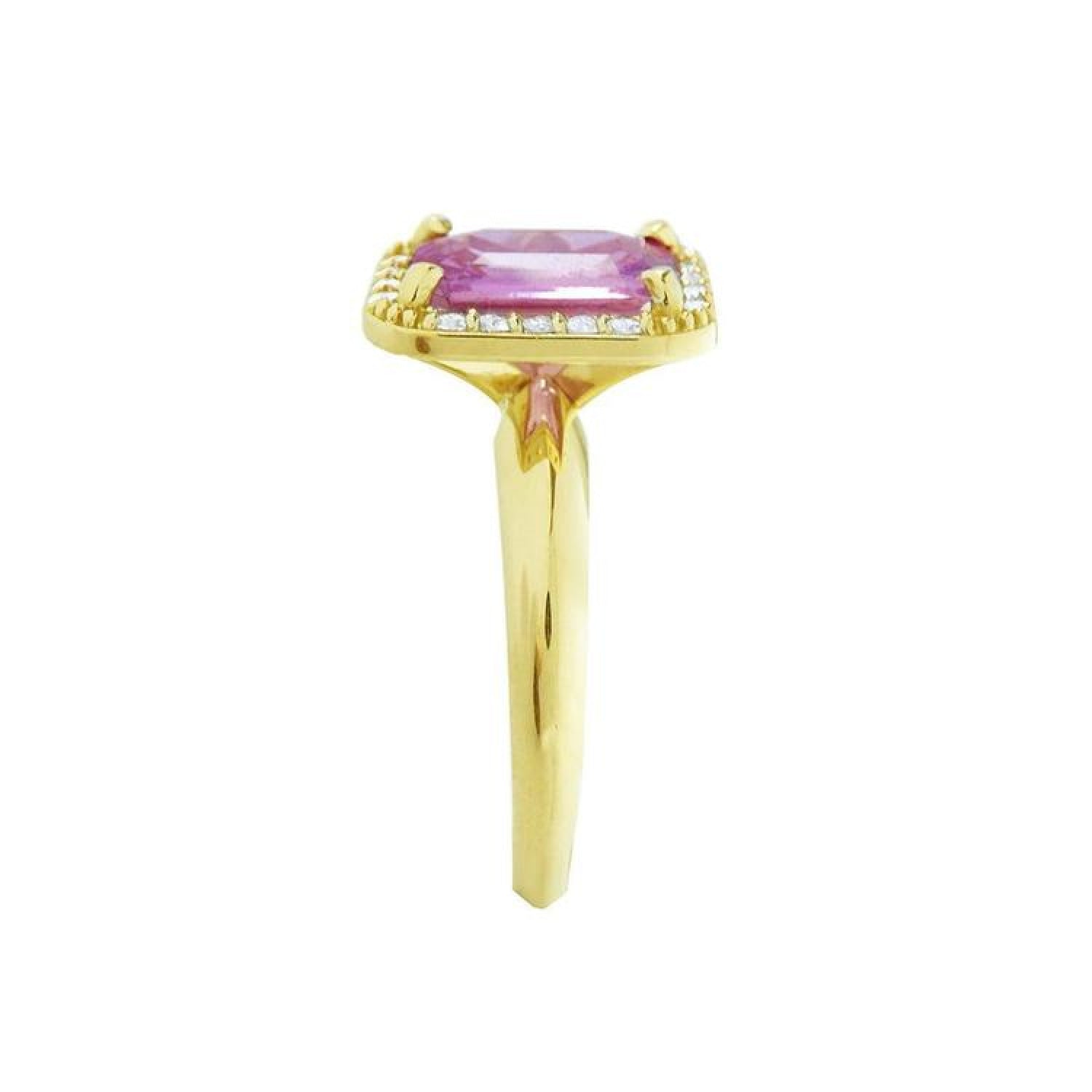 Emerald-cut pink sapphire ring with diamond halo in 14K yellow gold.