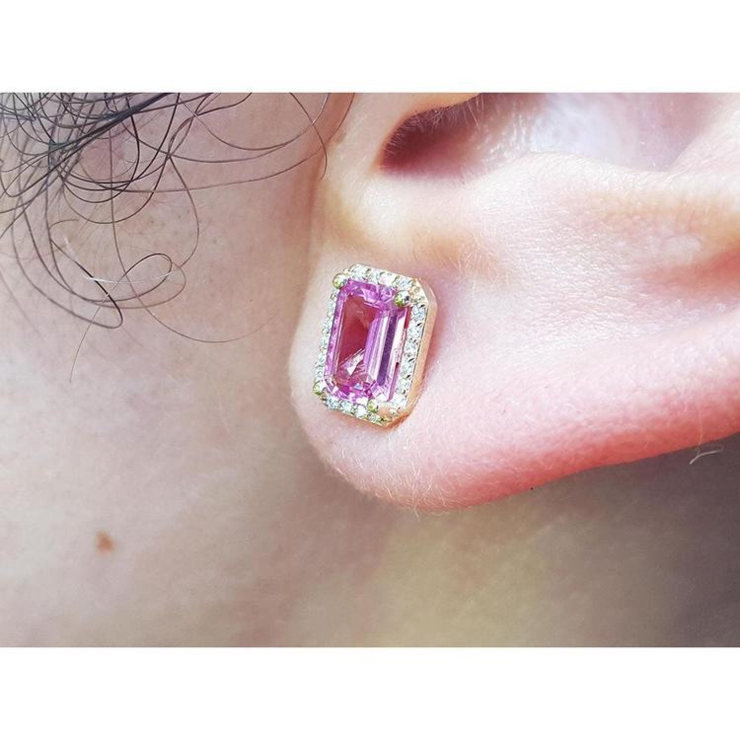 1.79 carat natural pink sapphire emerald cut stud earrings with halo diamonds in 14K yellow gold.