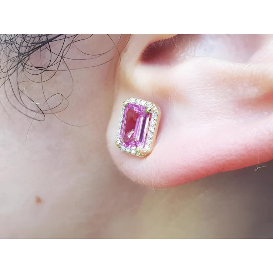 1.79 carat natural pink sapphire emerald cut stud earrings with halo diamonds in 14K yellow gold.