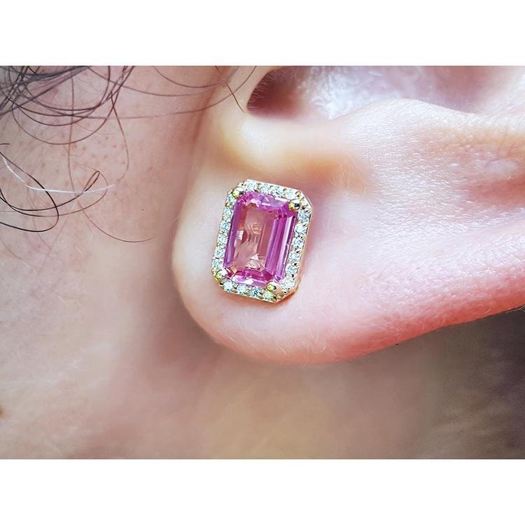  Natural pink sapphire stud earrings halo diamonds 14k yellow gold, worn on an ear close view