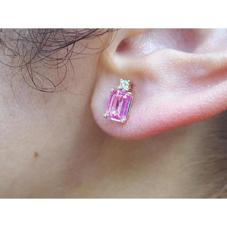 1.51 carat rectangular pink sapphire stud earrings with natural diamonds in 14K yellow gold on an ear.