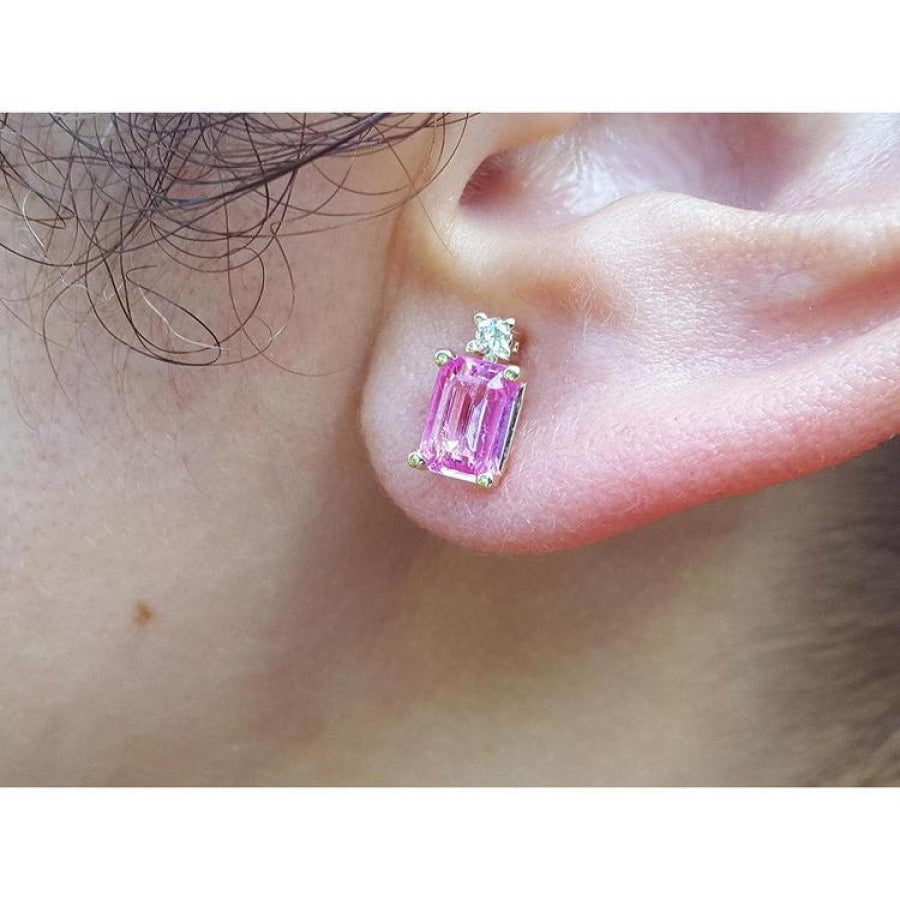 1.51 carat rectangular pink sapphire stud earrings with natural diamonds in 14K yellow gold on an ear.